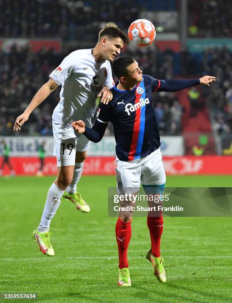 Luca Zander of St. Pauli jumps for a header with Fabian Reese of Kiel during the Second Bundesliga match between Holstein Kiel and FC St. Pauli at...