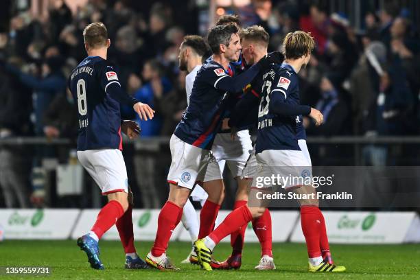 Benedikt Pichler of Kiel celebrates his team's third goal with teammates during the Second Bundesliga match between Holstein Kiel and FC St. Pauli at...