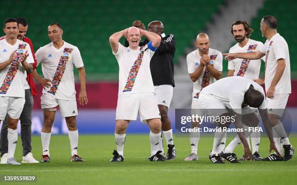 President Gianni Infantino, Javier Mascherano and Andrea Pirlo react during a penalty shoot out during the FIFA Legends friendly match between Arab...