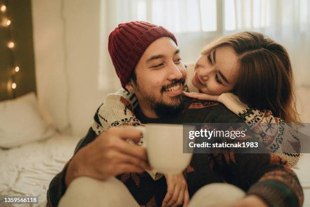 happy young couple relaxing talking laughing drinking coffee tea - coffee moustache stock pictures, royalty-free photos & images