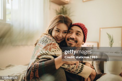Happy young couple relaxing talking laughing drinking coffee tea Happy young couple relaxing talking laughing drinking coffee tea