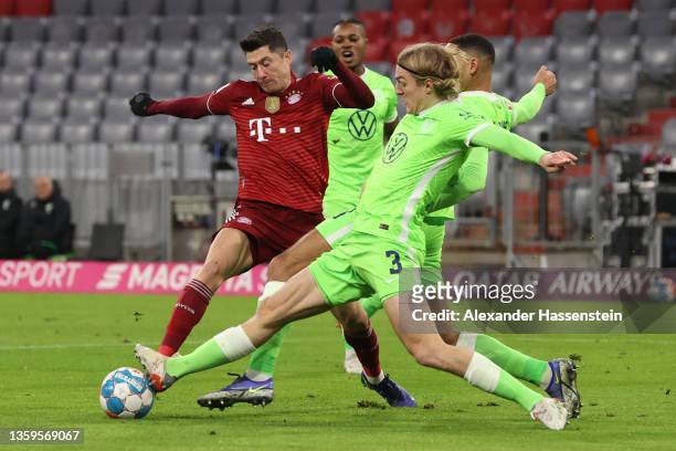Robert Lewandowski of Muenchen has his shot blocked by Sebastiaan Bornauw of Wolfsburg during the Bundesliga match between FC Bayern München and VfL...