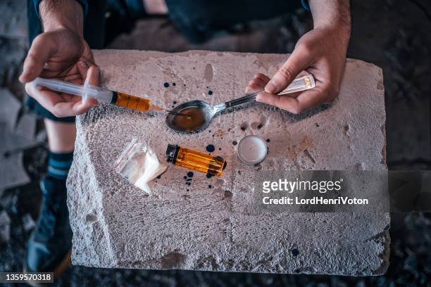 drug addict preparing his heroin fix - horse doping stock pictures, royalty-free photos & images