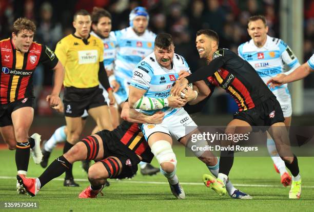 Gloucester players Jordy Reid and Adam Hastings combine to tackle Benetton player Sebastian Negri during the EPCR Challenge Cup match between...