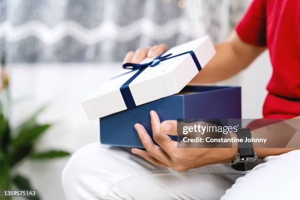 a person opening a gift box - recived stock pictures, royalty-free photos & images