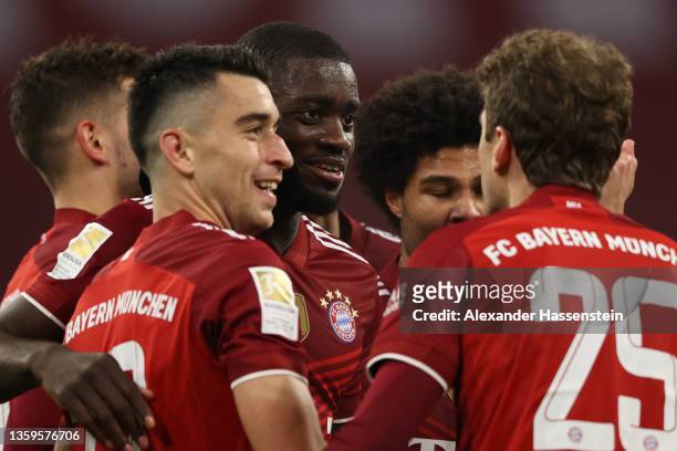 Dayot Upamecano of Muenchen celebrates his team's second goal with teammates during the Bundesliga match between FC Bayern München and VfL Wolfsburg...