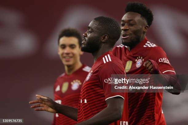 Dayot Upamecano of Muenchen celebrates his team's second goal with teammate Alphonso Davies during the Bundesliga match between FC Bayern München and...