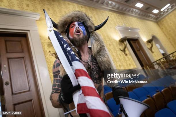Jacob Chansley, also known as the "QAnon Shaman," screams "Freedom" inside the U.S. Senate chamber after the U.S. Capitol was breached by a mob...