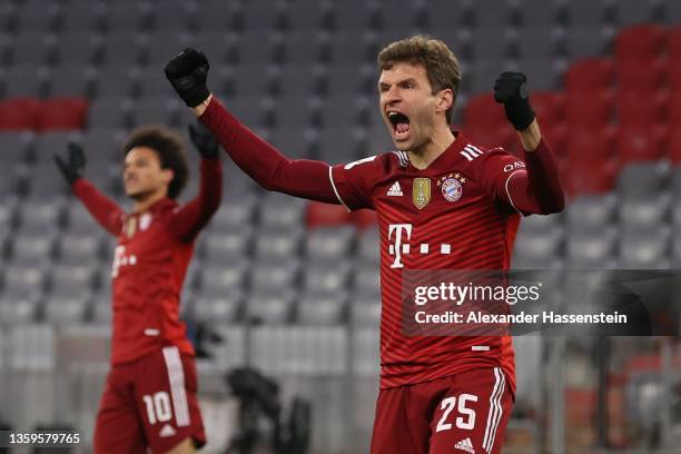 Thomas Mueller of Muenchen celebrates his team's first goal with teammate Robert Lewandowski during the Bundesliga match between FC Bayern München...