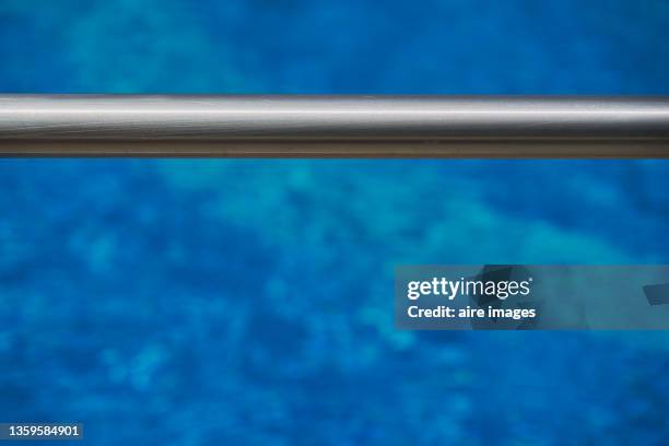 silver iron bar against a blue background - rod stock-fotos und bilder