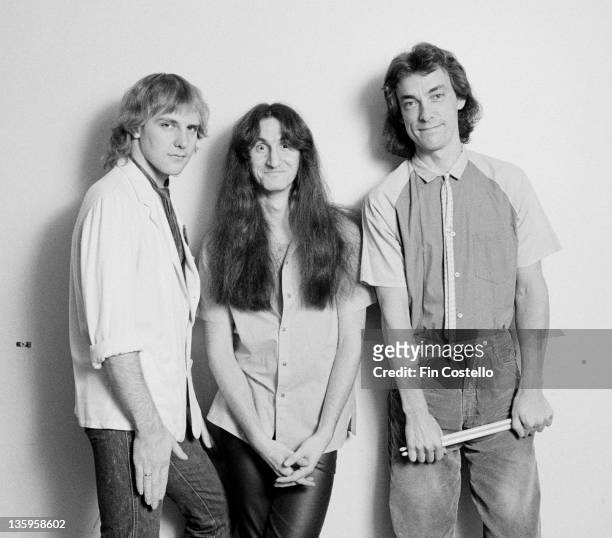 Alex Lifeson, Geddy Lee and Neil Peart from Canadian rock band Rush pose backstage during their Permanent Waves tour of England in June 1980.