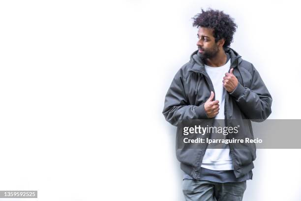 young black ethnicity with afro hair on a white background. portrait of a modern urban dancer man, copy paste space - rap ストックフォトと画像