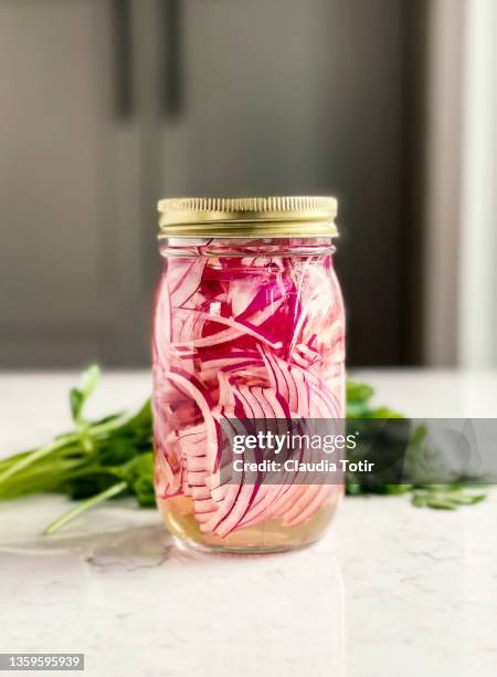 jar of pickled red onion on kitchen table - spanish onion stock pictures, royalty-free photos & images