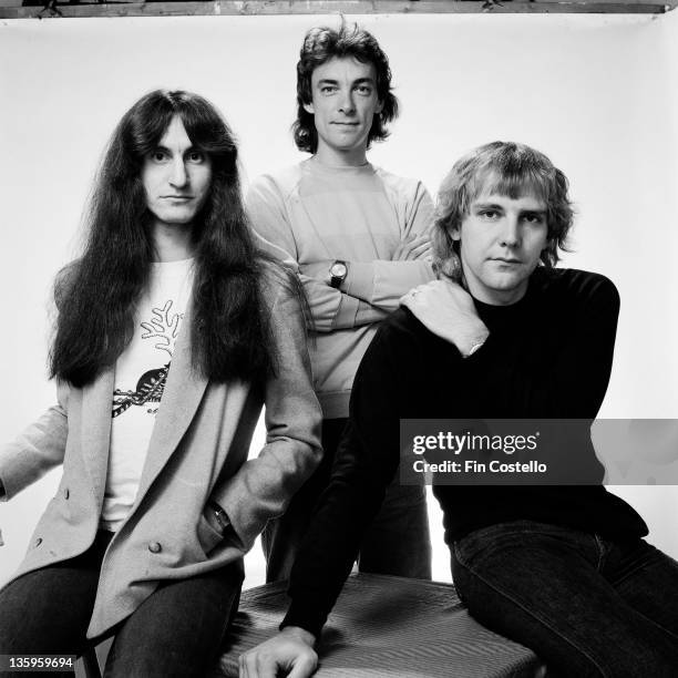 Canadian Progressive rock group Rush posed in a studio in London in June 1980. Left to right: bassist Geddy Lee, drummer Neil Peart and guitarist...