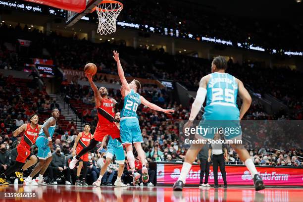 Damian Lillard of the Portland Trail Blazers is fouled while shooting by Gordon Hayward of the Charlotte Hornets during the first half at Moda Center...