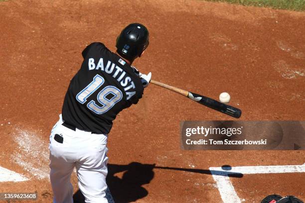 Jose Bautista of the Toronto Blue Jays hits a 2-run triple in the first inning during MLB game action against the Detroit Tigers at the Rogers Centre...