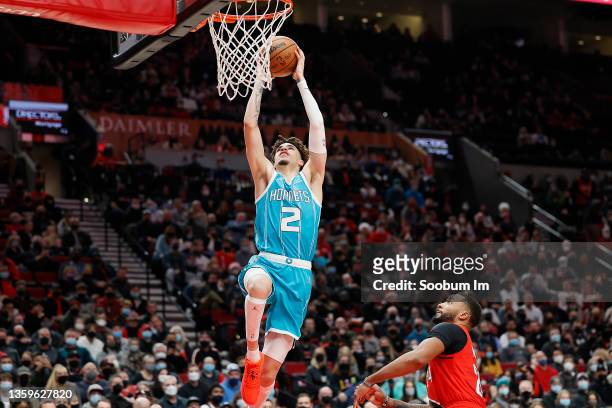 LaMelo Ball of the Charlotte Hornets dunks the ball past Norman Powell of the Portland Trail Blazers during the second half against the Portland...