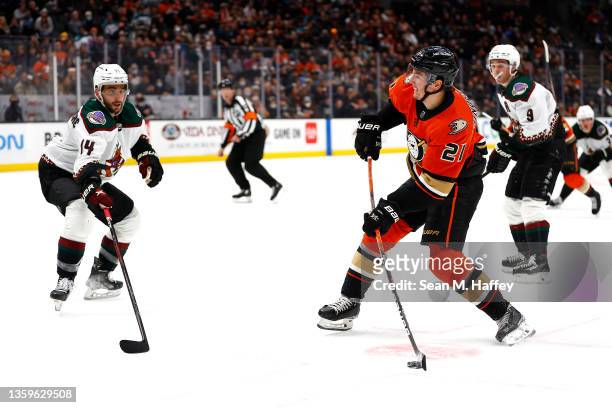 Isac Lundestrom of the Anaheim Ducks shoots the puck past the defense of Shayne Gostisbehere of the Arizona Coyotes during the third period of a game...