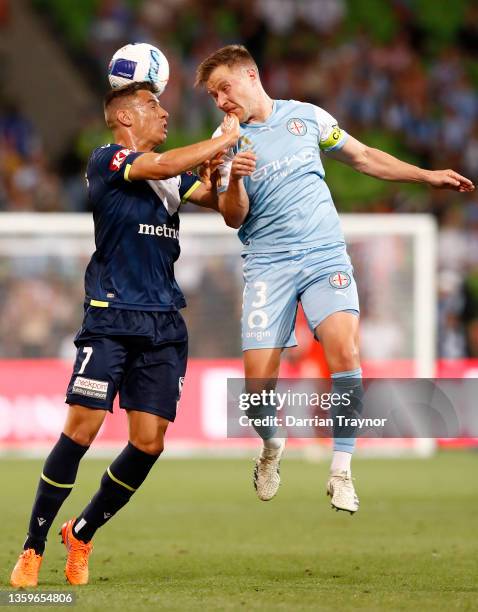 Chris Ikonomidis of Melbourne Victory and Scott Jamieson of Melbourne City compete in the air during the A-League mens match between Melbourne City...