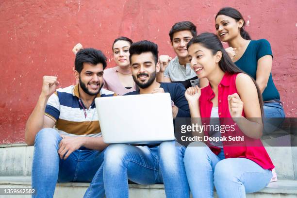 group of happy college student:- stock photo - indian ethnicity stockfoto's en -beelden