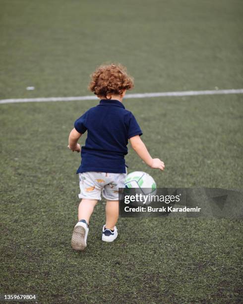 cute boy playing football - baby kicking stock pictures, royalty-free photos & images