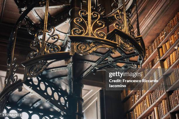 old library, books and spiral staircase - research literature stock pictures, royalty-free photos & images