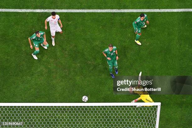 Rais Mbolhi of Algeria dives for the ball as it hits the crossbar during the FIFA Arab Cup Qatar 2021 Final match between Tunisia and Algeria at Al...