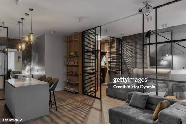 stylish modern studio apartment in the grey tones - design bedroom stock-fotos und bilder