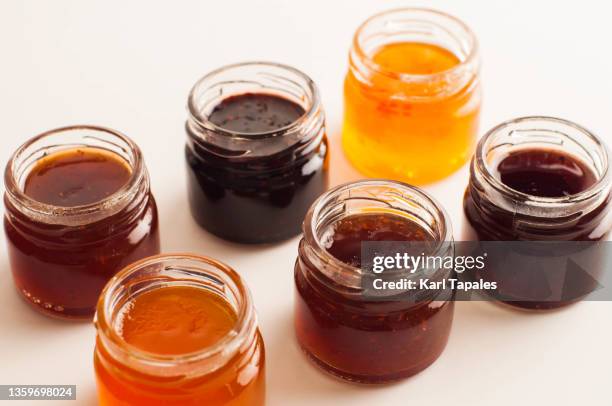 financial concepts background variety of preserved fruit jams - marmalade stockfoto's en -beelden