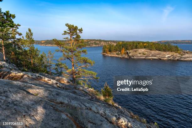view of the colorful islands from the high shore of the lake in an autumn evening - lake ladoga stock pictures, royalty-free photos & images