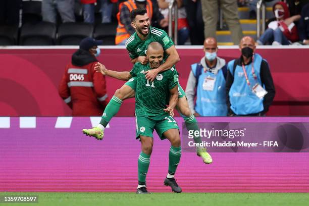 Yacine Brahimi of Algeria celebrates with teammate Amir Sayoud after scoring their team's second goal during the FIFA Arab Cup Qatar 2021 Final match...