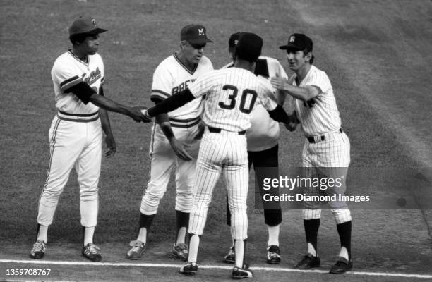 Second baseman Willie Randolph of the New York Yankees and the American League team shakes hands with teammates Rod Carew of the Minnesota Twins,...