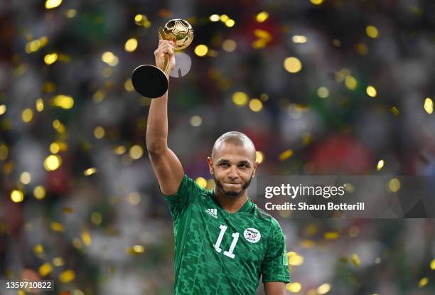 Yacine Brahimi of Algeria receives the Adidas Golden Ball award following the FIFA Arab Cup Qatar 2021 Final match between Tunisia and Algeria at Al...