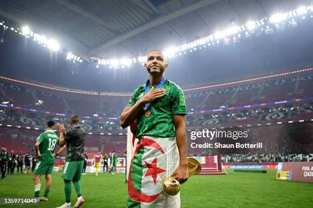 Yacine Brahimi of Algeria celebrates with the FIFA Arab Cup trophy following victory during the FIFA Arab Cup Qatar 2021 Final match between Tunisia...