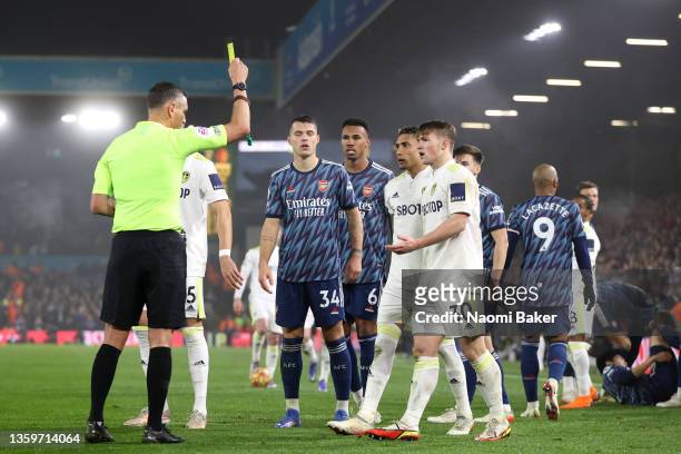 Joe Gelhardt of Leeds United is shown a yellow card by referee Andre Marriner during the Premier League match between Leeds United and Arsenal at...