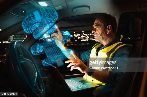 engineer working on digitalized graphs in car - augmented reality car stock pictures, royalty-free photos & images