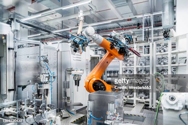 robotic arm in manufacturing industry - smart factory stock pictures, royalty-free photos & images
