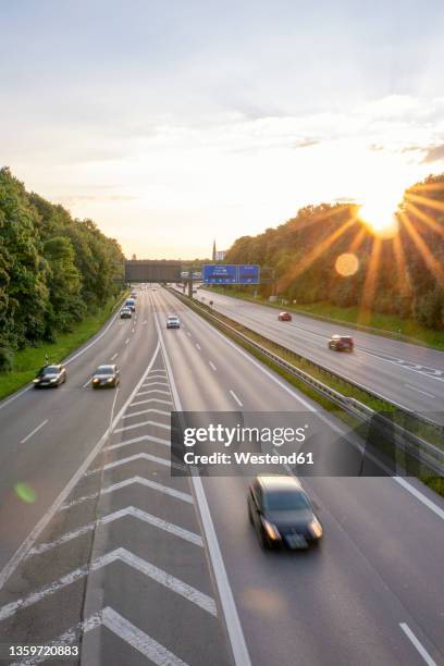 germany, bavaria, munich, traffic onbundesautobahn96 at sunset - autobahn germany stock pictures, royalty-free photos & images