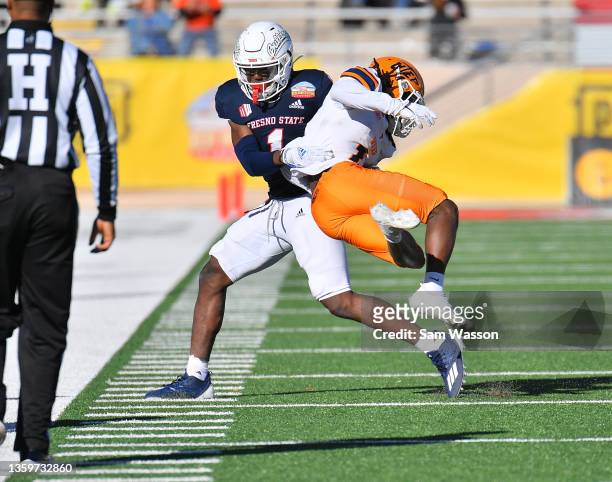 Defensive back DaRon Bland of the Fresno State Bulldogs tackles wide receiver Tyrin Smith of the UTEP Miners on a kickoff return during the first...