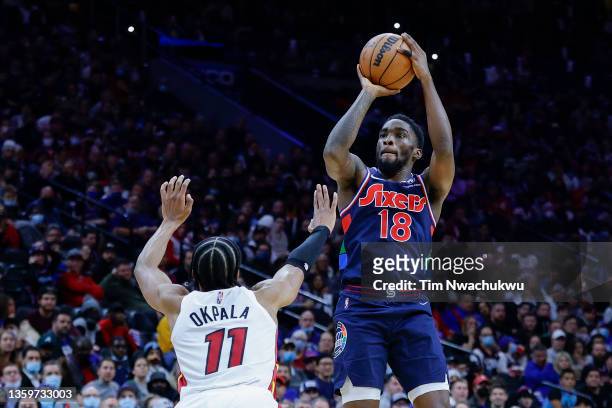 Shake Milton of the Philadelphia 76ers shoots over KZ Okpala of the Miami Heat at Wells Fargo Center on December 15, 2021 in Philadelphia,...