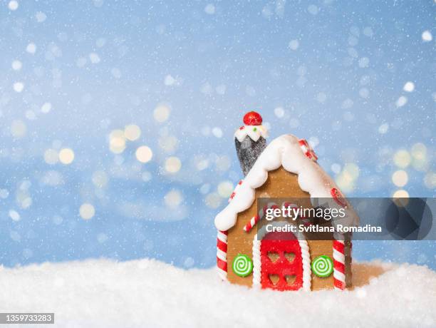 christmas card  with gingerbread house , snow and christmas lights illumination with bokeh - gingerbread house stock pictures, royalty-free photos & images