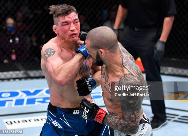 Cub Swanson punches Darren Elkins in their featherweight fight during the UFC Fight Night event at UFC APEX on December 18, 2021 in Las Vegas, Nevada.