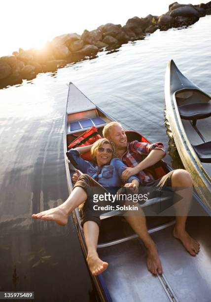 couple laying together in canoe - dänemark gemütlich stock-fotos und bilder