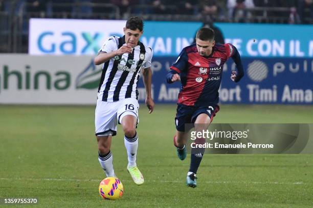 Udinese Calcio Nahuel Molina in action and competes for the ball against Cagliari Calcio Razvan Marin during the Serie A match between Cagliari...