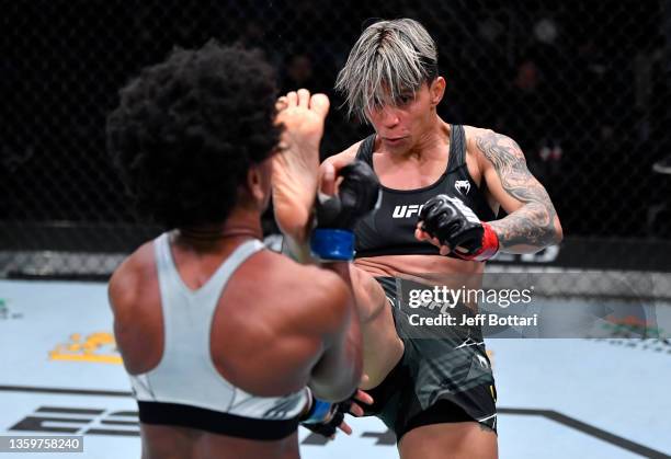 Amanda Lemos of Brazil kicks Angela Hill in their bantamweight fight during the UFC Fight Night event at UFC APEX on December 18, 2021 in Las Vegas,...