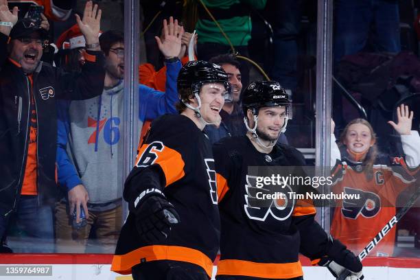 Travis Sanheim and Scott Laughton of the Philadelphia Flyers celebrate after Sanheim scores the game-winning goal against the Ottawa Senators at...
