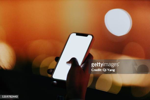 close-up of using smartphone at night - dark cells stock pictures, royalty-free photos & images