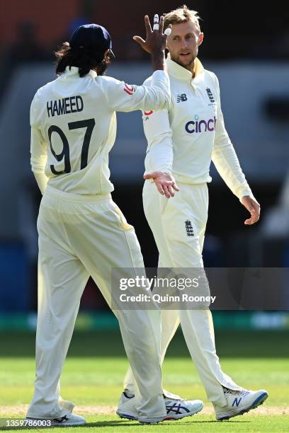 Joe Root of England celebrates with Haseeb Hameed of England after taking the wicket of Alex Carey of Australia for 6 runs during day four of the...