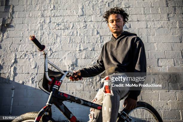 portrait of young male bmx rider in urban area - music inspired fashion stock pictures, royalty-free photos & images