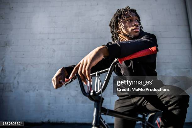 portrait of young male bmx rider in urban area - african american male style stock-fotos und bilder